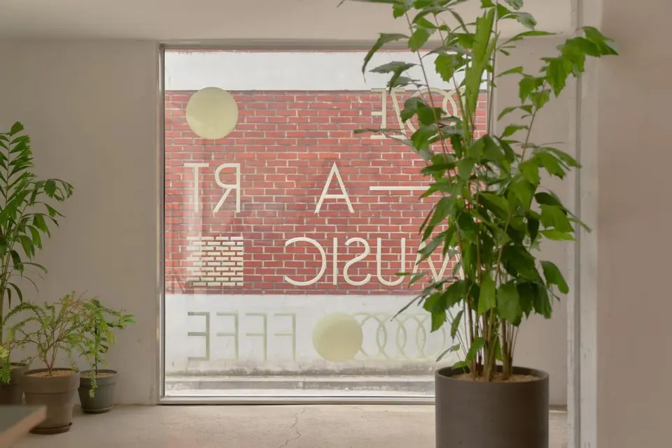 Cafe interior with plants and large windows