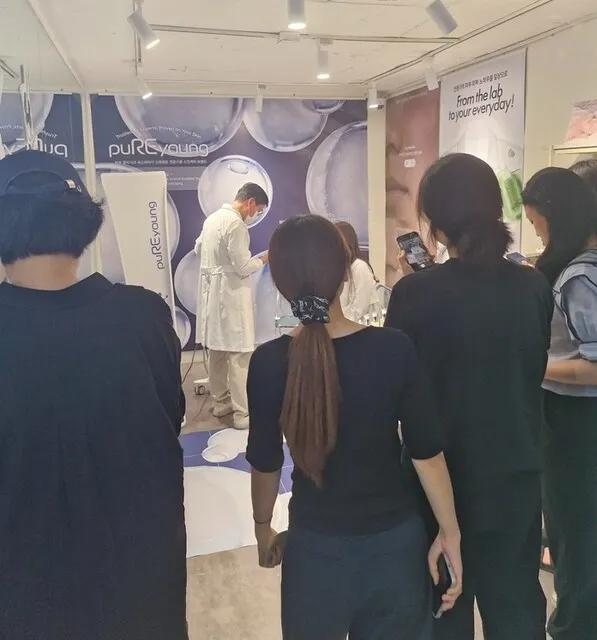 Visitors listening to a staff member in a white coat